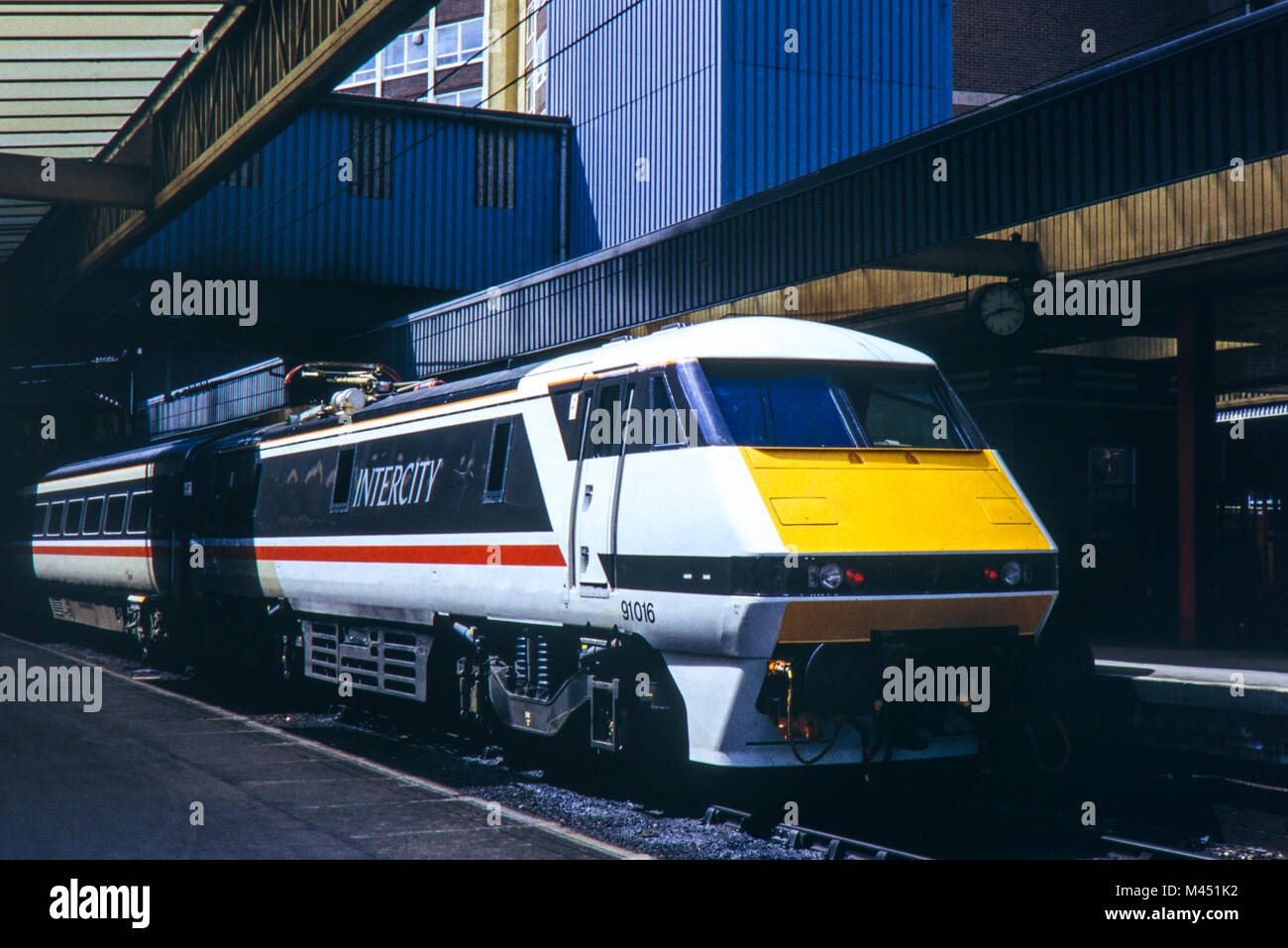 InterCity 225 is an electric high speed train in the United Kingdom. This Class 91 numbered 91016 with a Swallow design livery at Leeds 6th July 1990 Stock Photo
