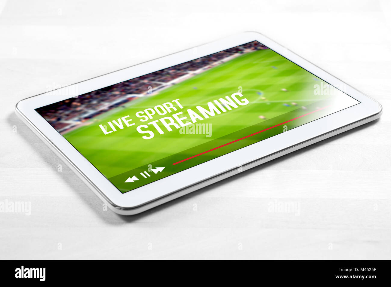 Live sport stream online with mobile device. White tablet on wooden table with imaginary video player and streaming service. Stock Photo