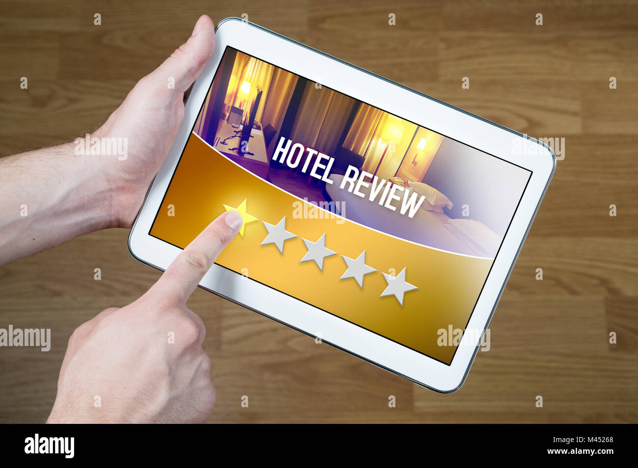 Bad hotel review. Disappointed and dissatisfied customer giving terrible rating with tablet on an imaginary criticism site, application or website. Stock Photo