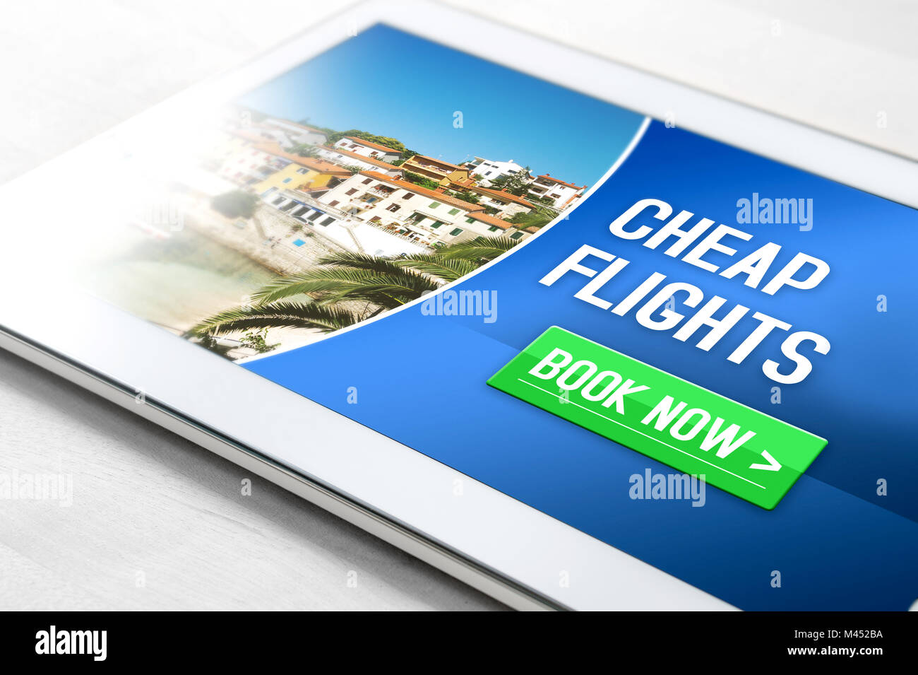 Cheap flights for sale on internet. Close up of tablet on table with affordable and inexpensive vacation offer on screen. Stock Photo