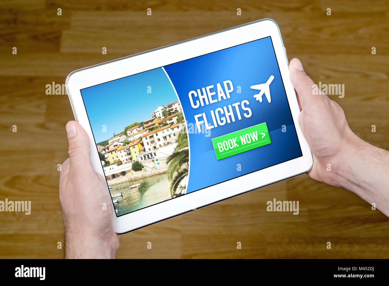 Hands holding tablet with cheap flghts for sale add on internet. Affordable and inexpensive vacation offer on screen. Stock Photo