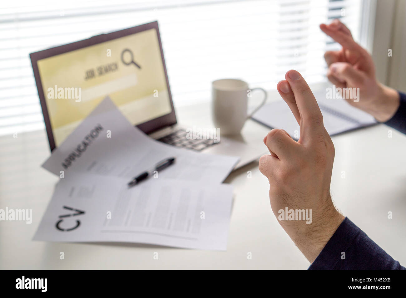 Fingers crossed to get work. Hopeful jobseeker with positive attitude. Motivated job applicant hoping to get hired after applying. Successful. Stock Photo