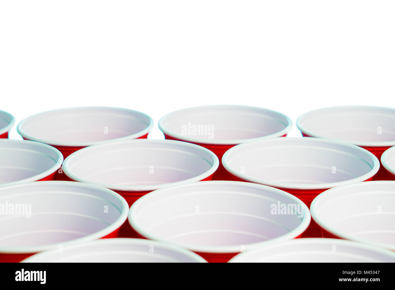 Many red party cups isolated on white. Close up of college alcohol containers with free empty blank copy space for text. Event marketing and promotion Stock Photo