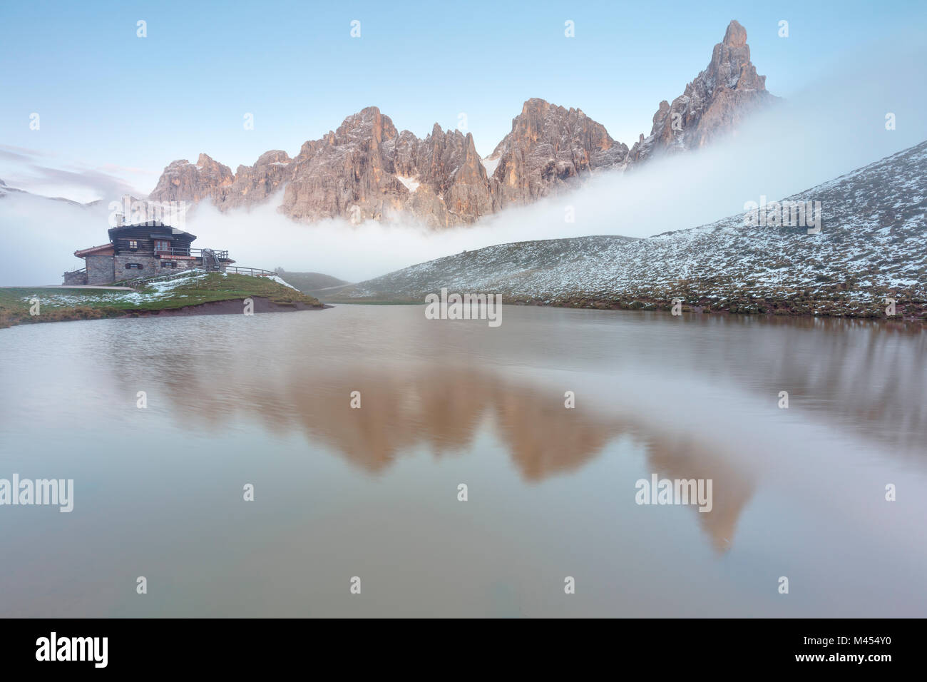 Dolomites Alps, Pale di San Martino reflecting on water with clouds, Baita Segantini, Trentino Alto Adige District, Italy Stock Photo