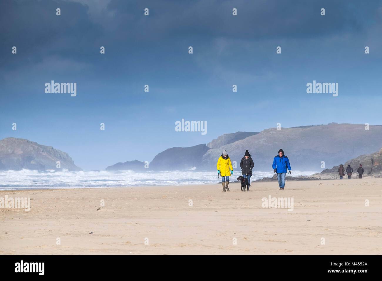 Walkers on Perranporth Beach in Cornwall UK. Stock Photo