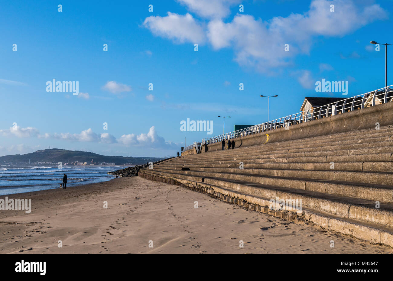 Aberavon Beach looking west, south Wales, with people out walking Stock Photo