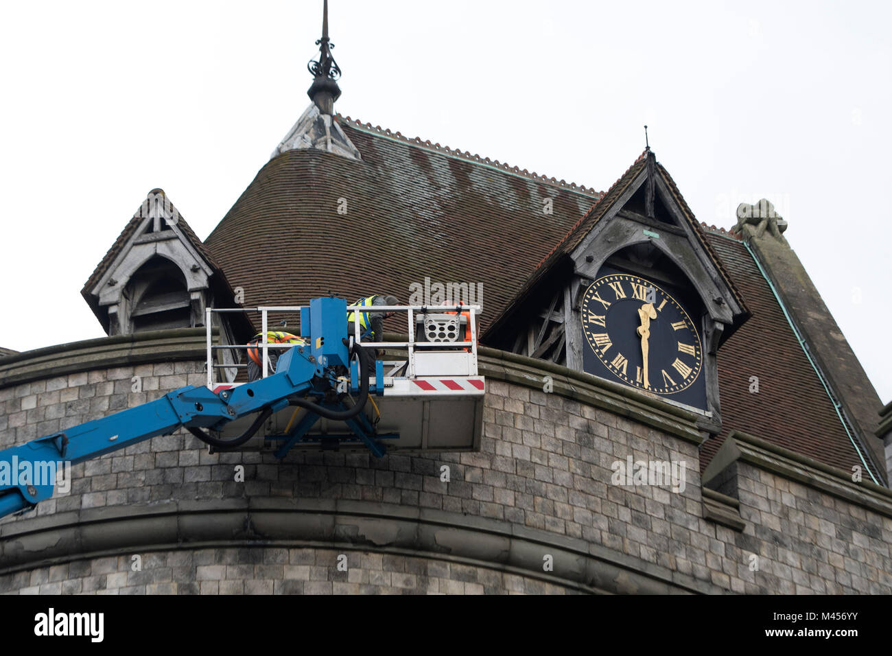 The Round Tower in Windsor Castle being inspected by workmen in a very tall cherry picker Stock Photo