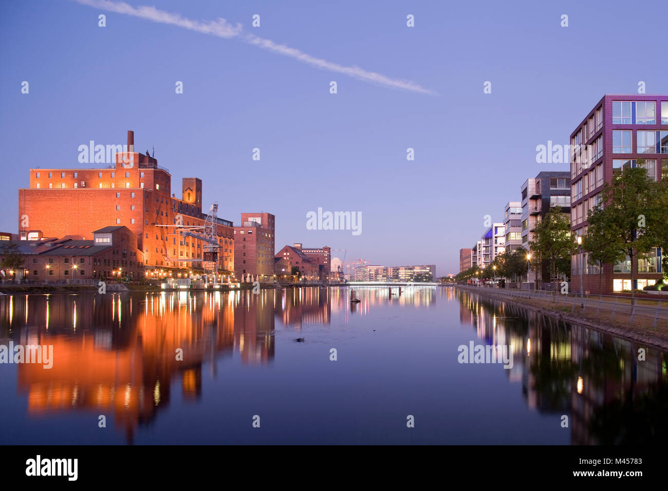 Old storehouses and modern office buildings face to face at the old harbour in Duisburg, Germany Stock Photo