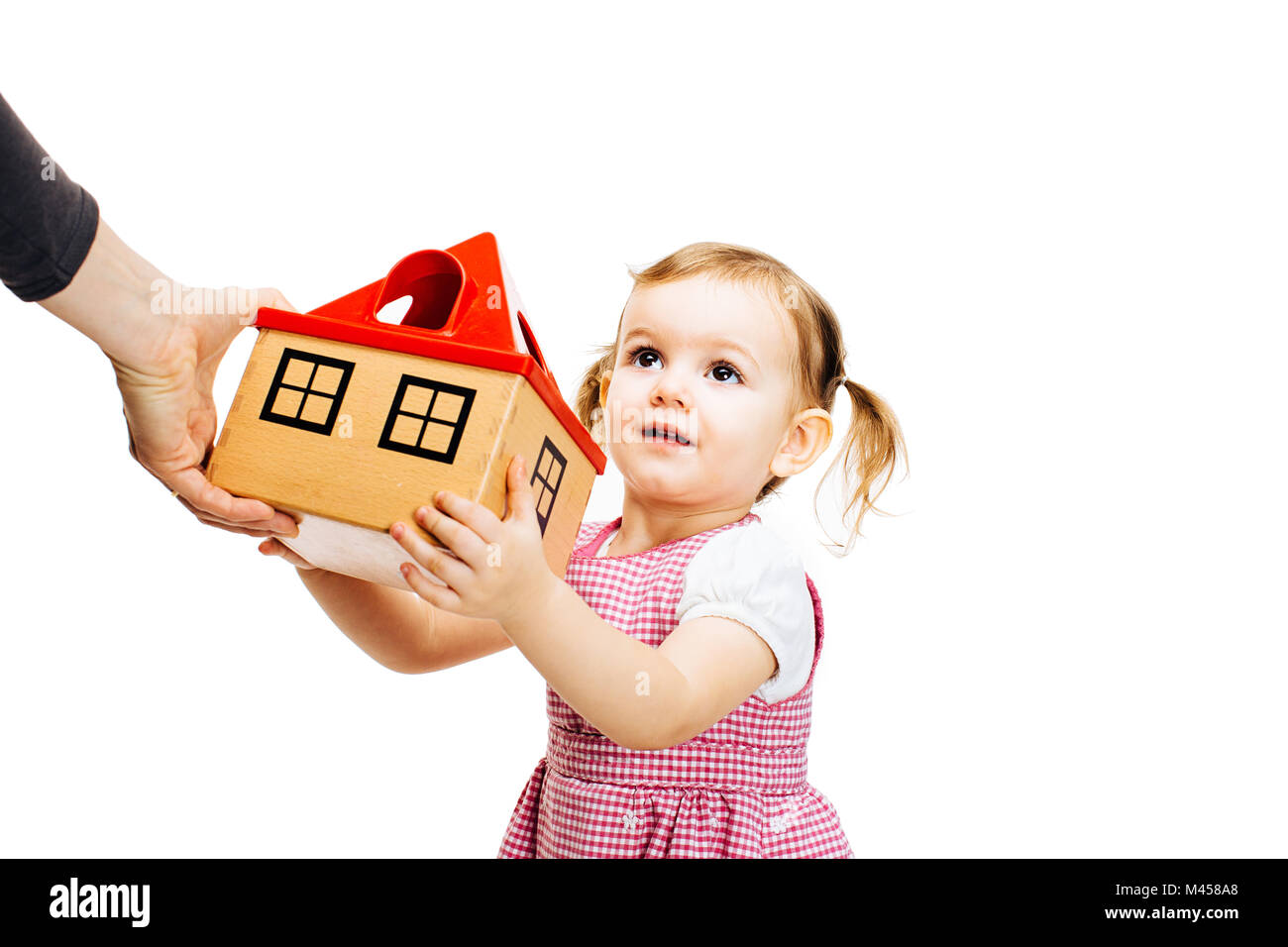 toddler girl receiving a house Stock Photo