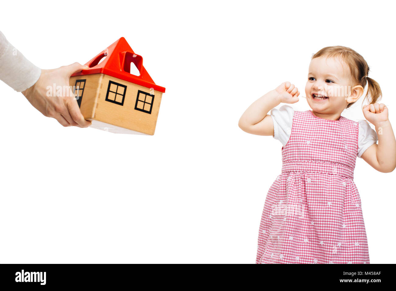 Happy toddler girl receiving a toy house Stock Photo