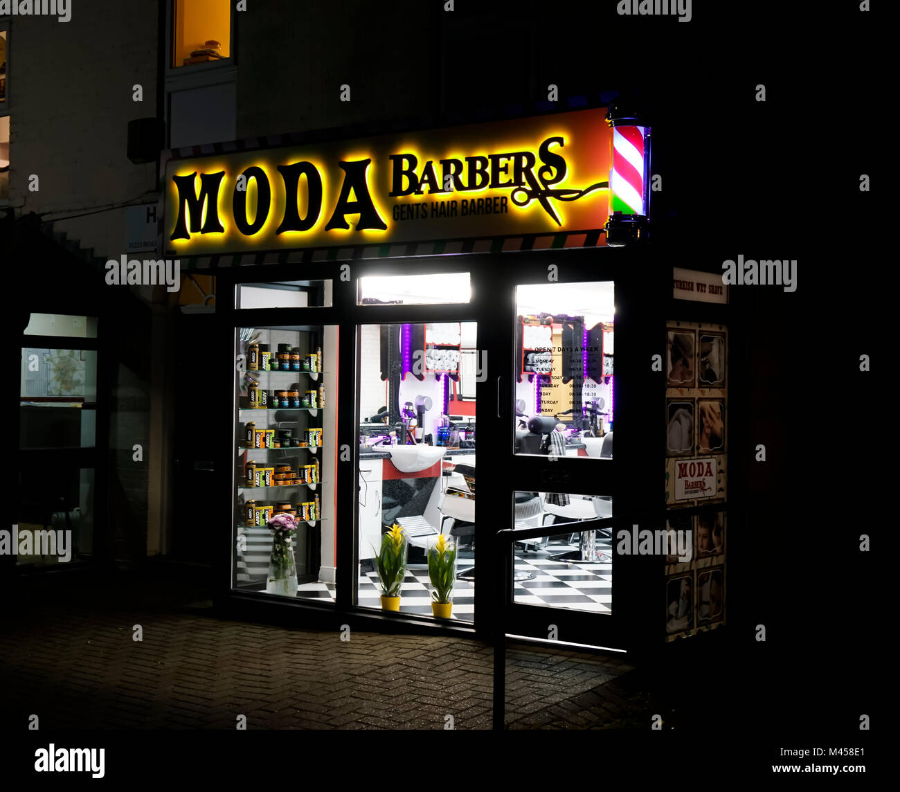 Moda barbers hair salon at night in Milton Cambridge Cambridgeshire England Stock Photo