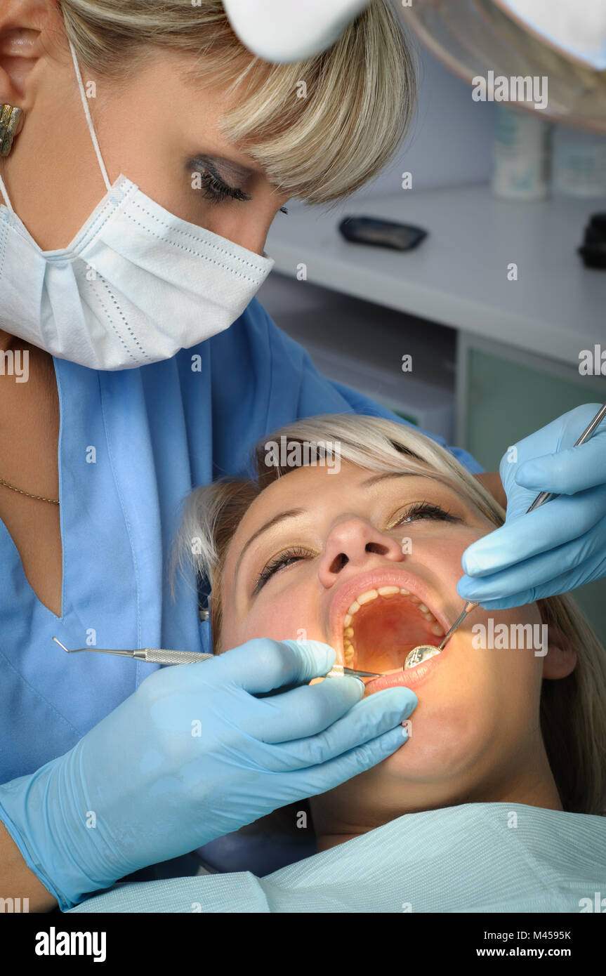 dentist with patient, dental calculus removal Stock Photo Alamy