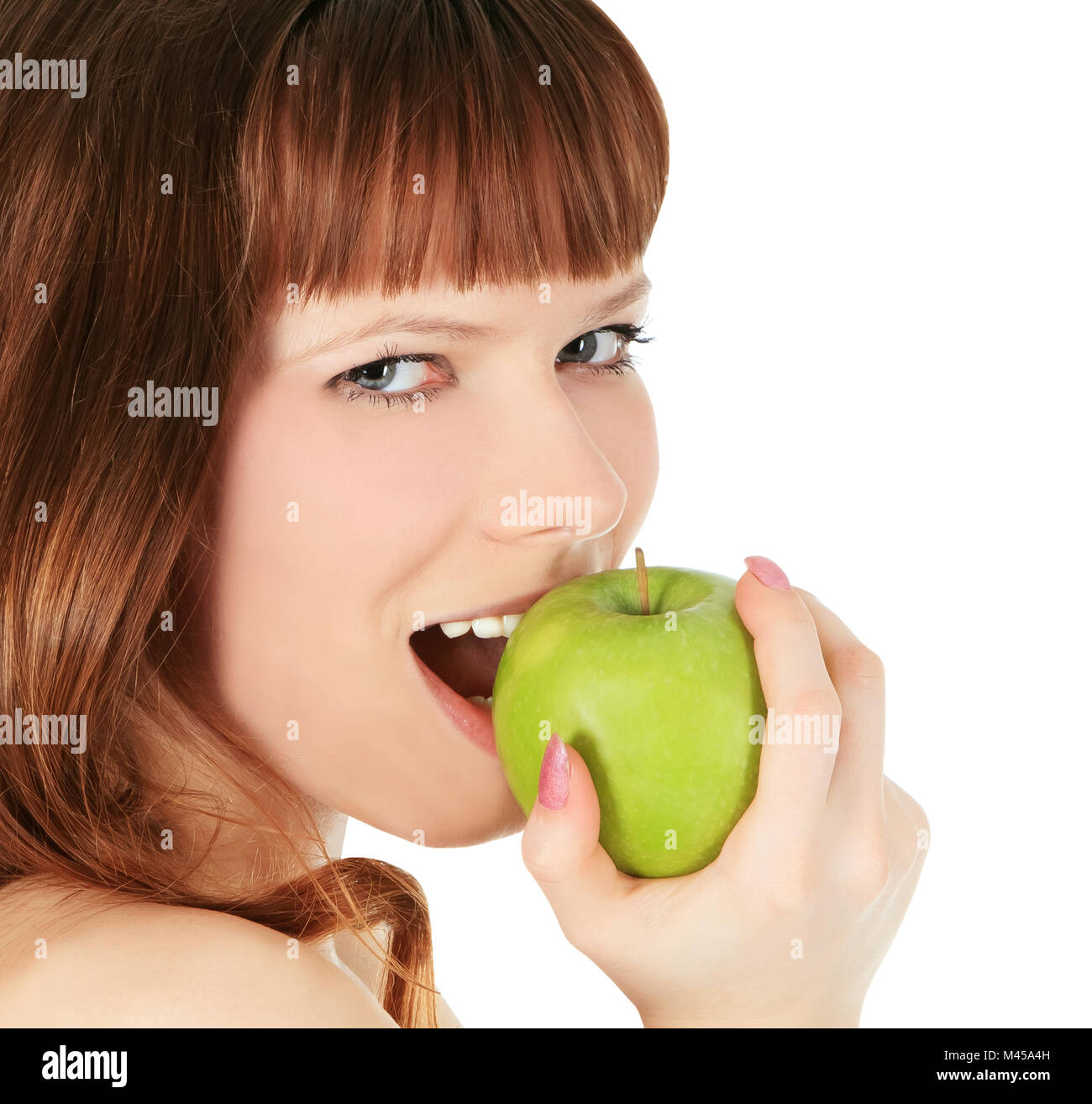 woman eating a green apple isolated over white background Stock Photo