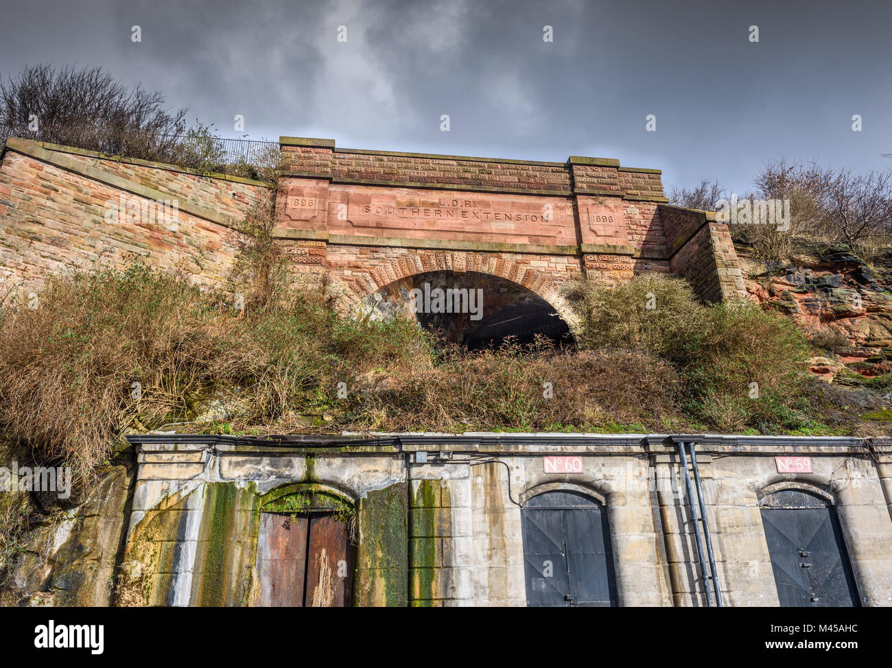 The abandoned Southern extension tunnel portal at Herculaneum Dock, built in 1896,Liverpool through a sandstone face. The Liverpool Overhead Railway Stock Photo