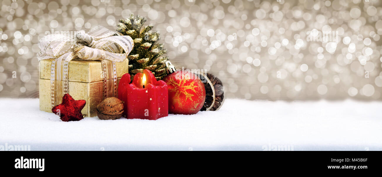 Christmas gift box with decoration isolated on golden background. Stock Photo