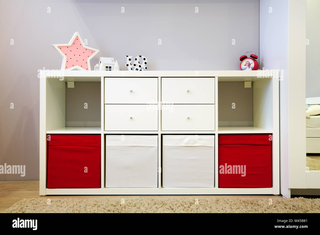 System for storage toys in children room. Safty storage system with soft boxes for children. Stock Photo
