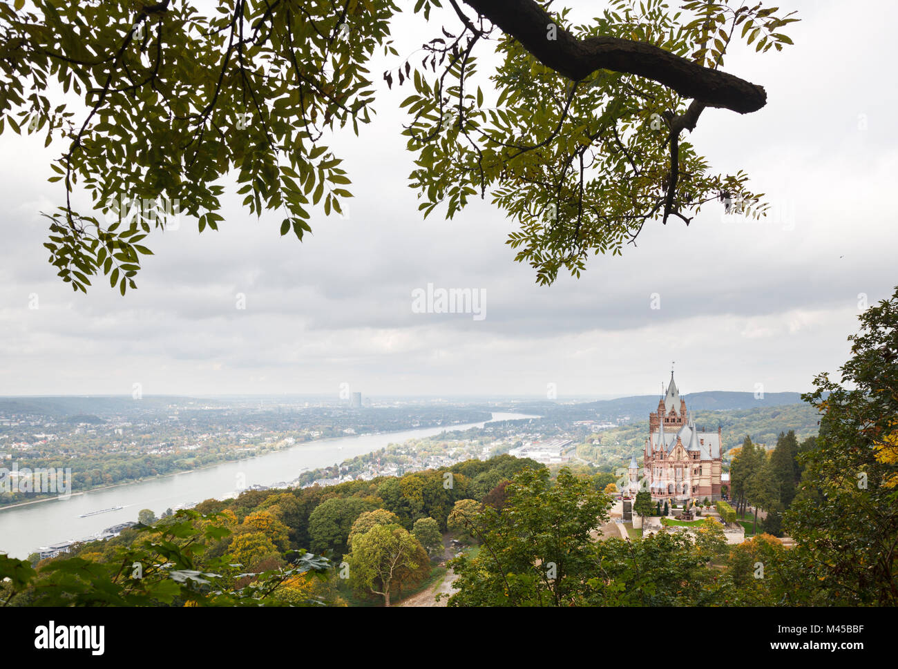 Castle Drachenburg (Schloss Drachenburg) at the Drachenfels near Koenigswinter in Germany with view over the Rhine to Bonn. Stock Photo