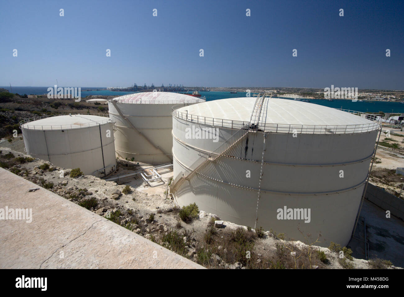 Three oil tanks in mediterranean landscape, Malta. Stock Photo