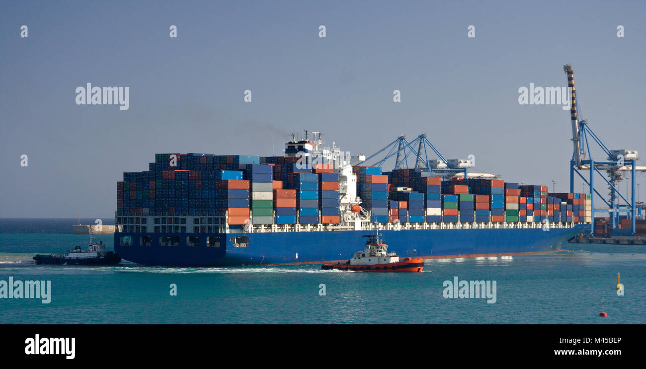 A giant container ship in the harbor of Birzebbuga, Malta. Stock Photo