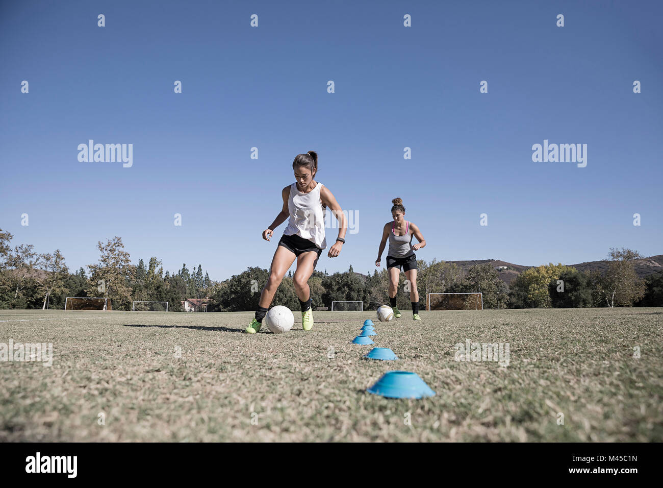 Women dribbling footballs Stock Photo Alamy