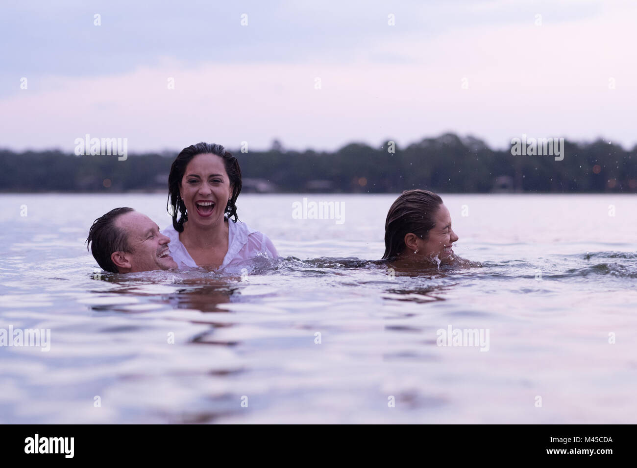 Clothed friends in water, Destin, Florida, United States, North America Stock Photo