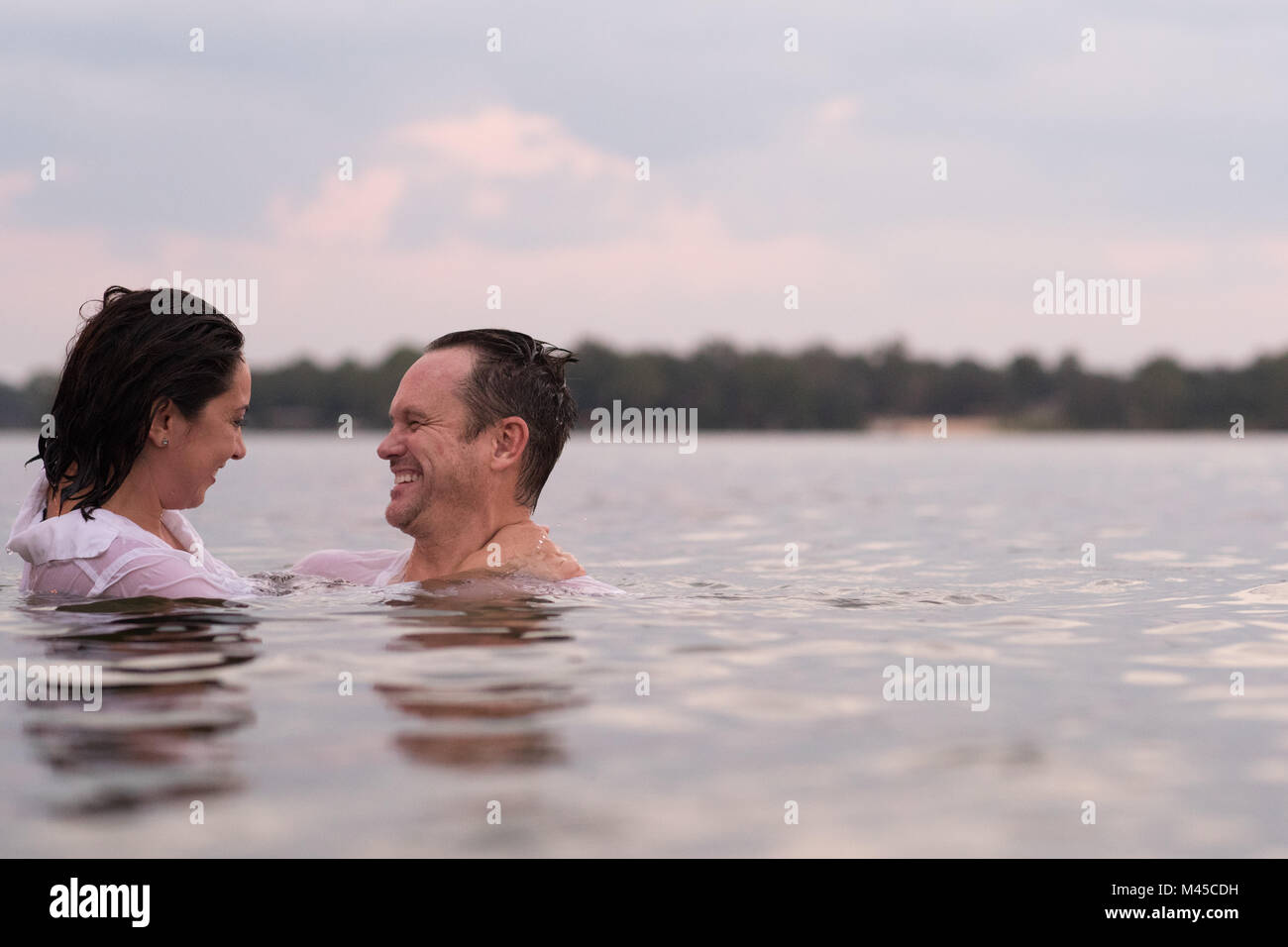 Clothed couple in water, Destin, Florida, United States, North America Stock Photo