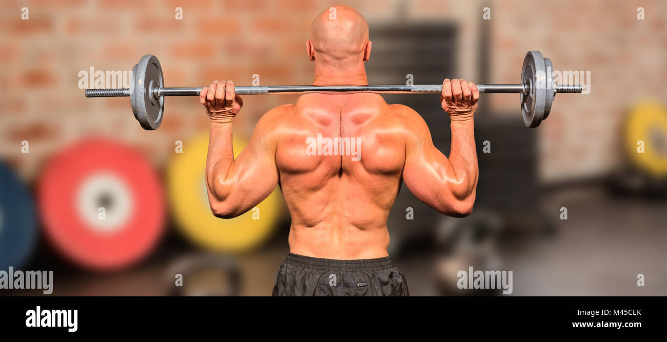 Composite image of rear view of bodybuilder lifting crossfit Stock ...