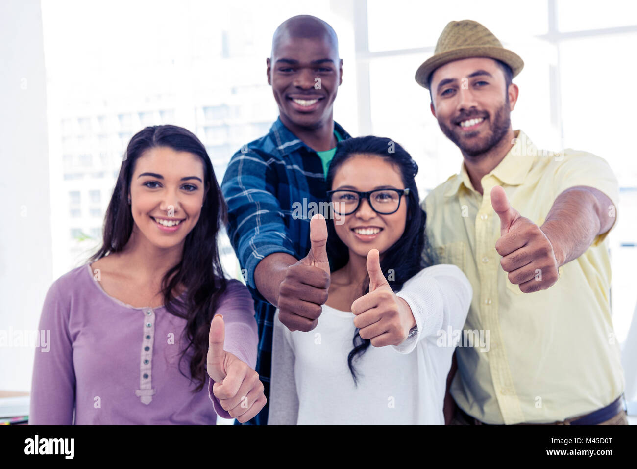 Portrait of creative business people showing thumbs up Stock Photo - Alamy