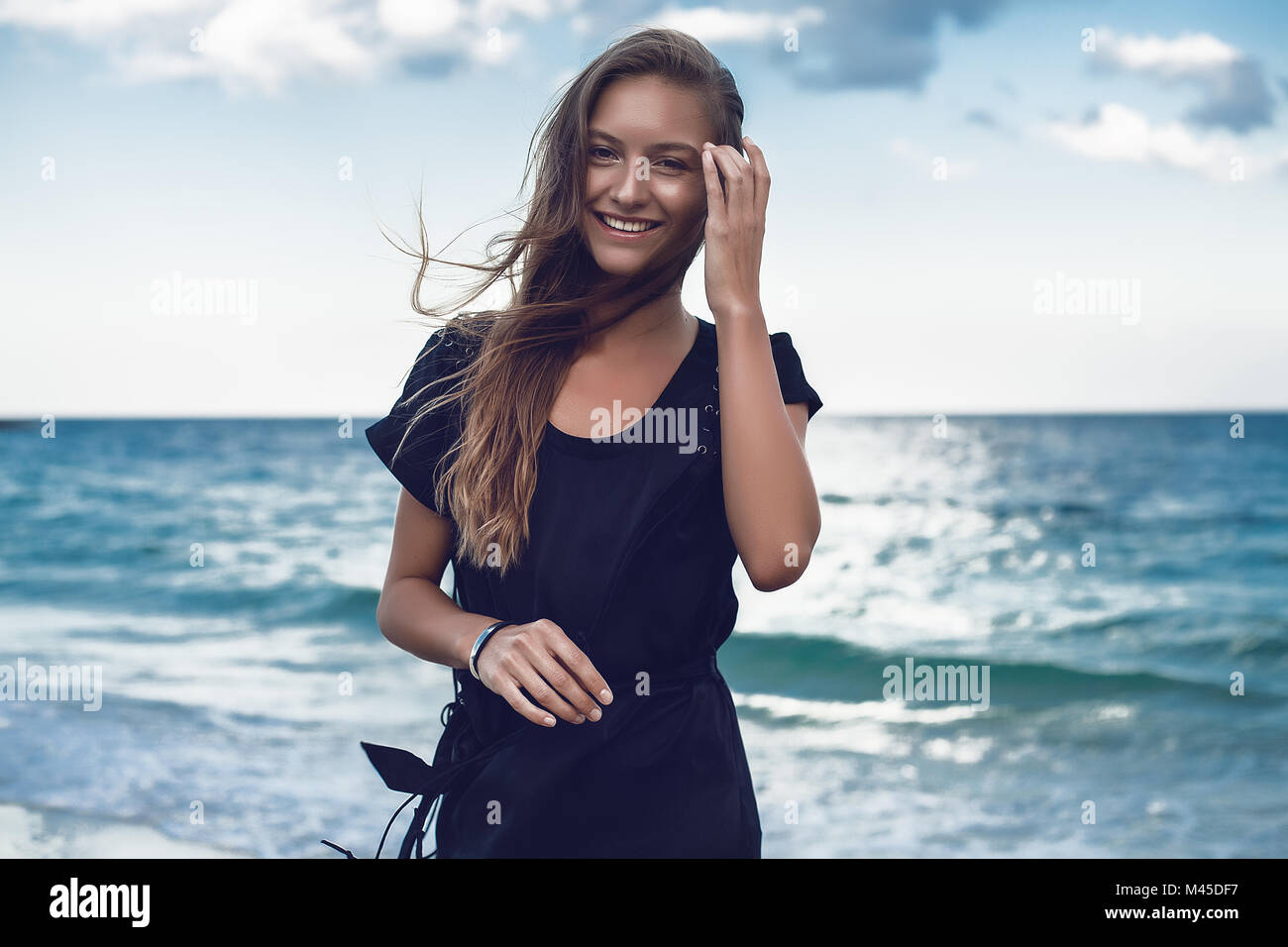 Portrait of happy young woman on beach, Odessa, Odessa Oblast, Ukraine Stock Photo