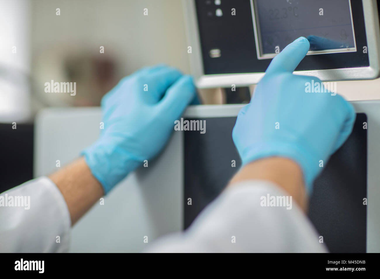 Male worker in thread factory, using touch screen, close-up Stock Photo
