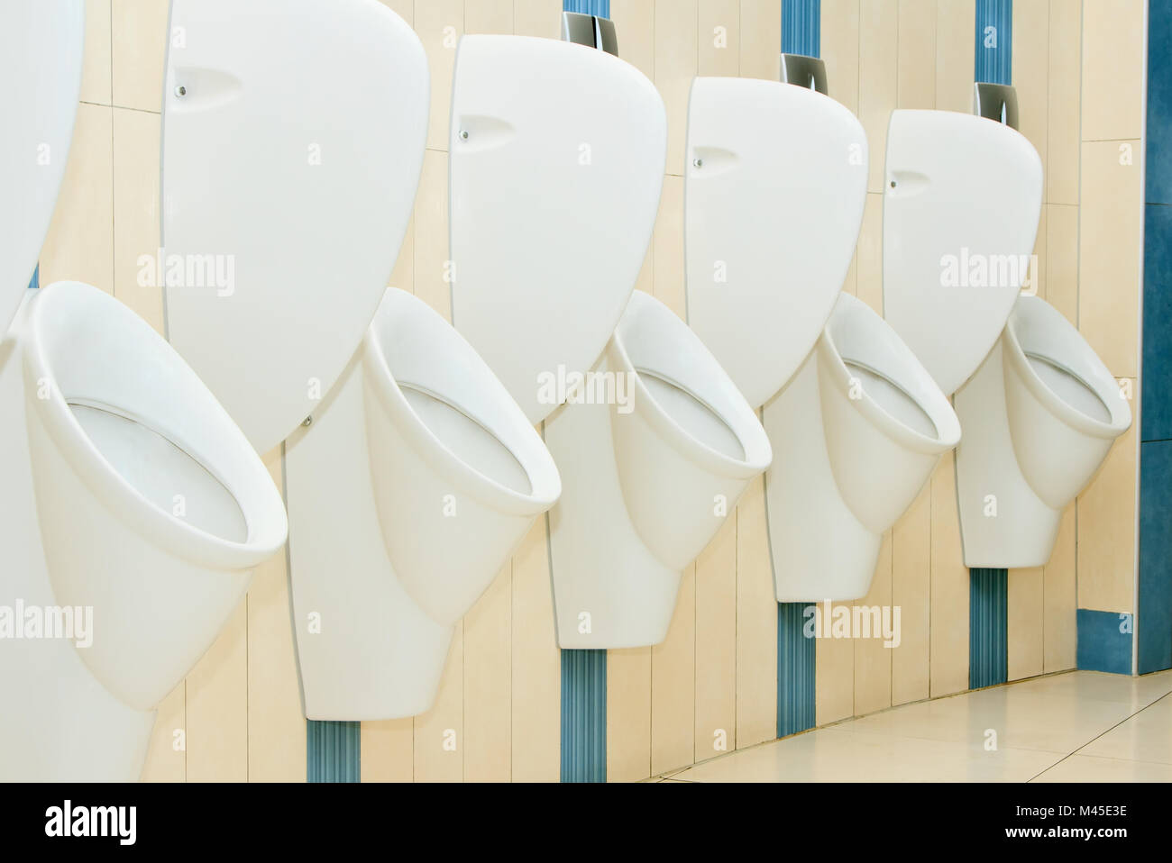 modern restroom interior with urinal row Stock Photo