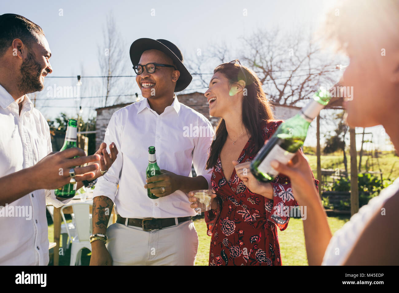 Happy young people having fun at the party and drinking beer. Group of ...