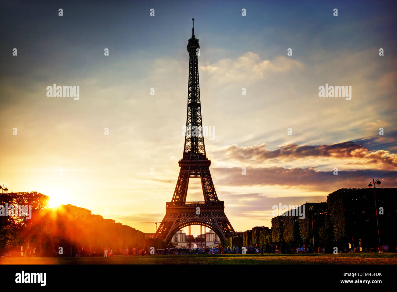 Eiffel Tower seen from Champ de Mars at sunset Stock Photo