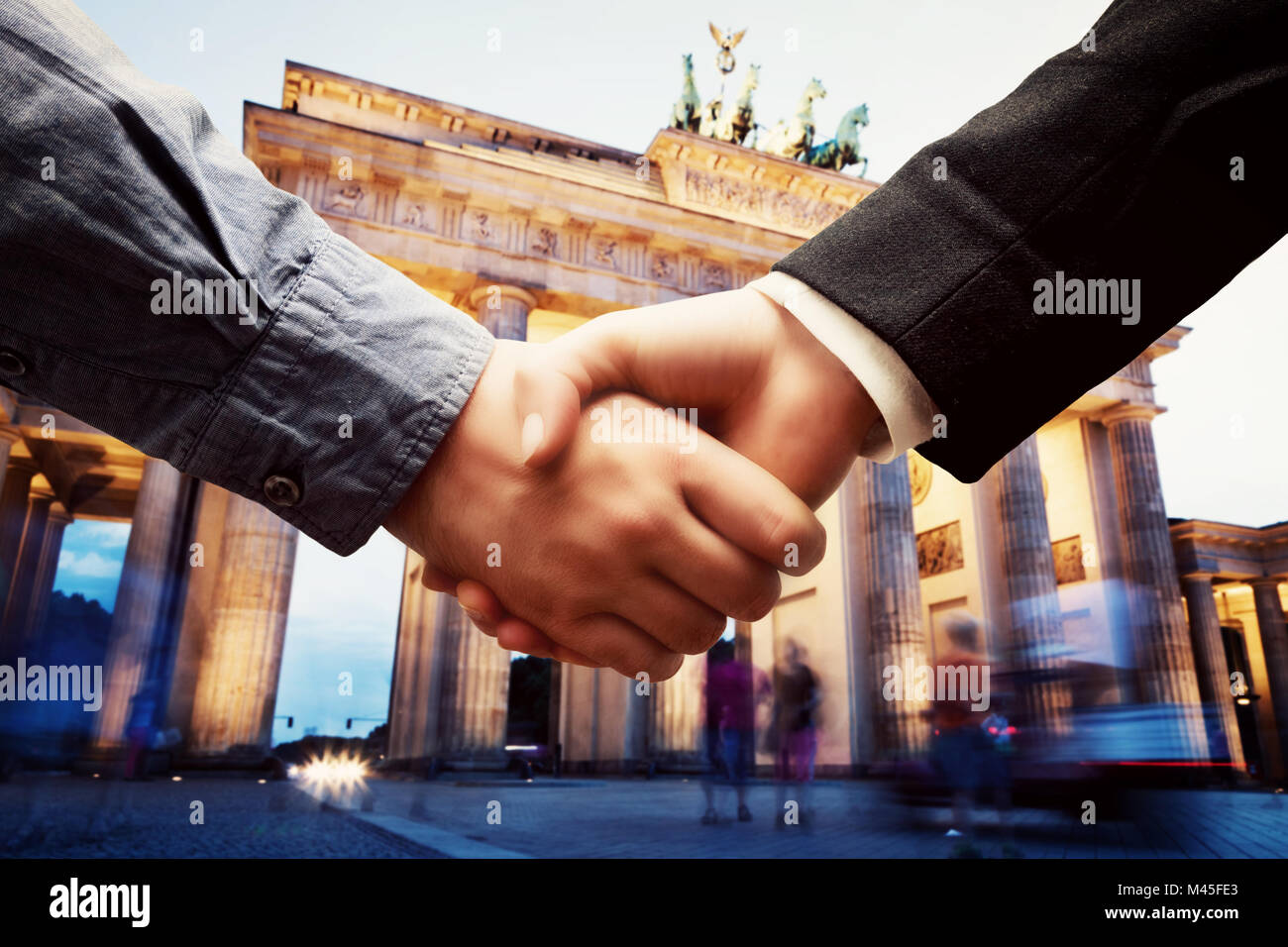 Business in Berlin. Handshake on Brandenburg Gate background. Deal Stock Photo