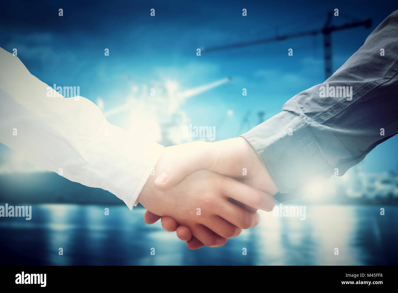 Business handshake in shipyard. Industry, deal, contract. Stock Photo