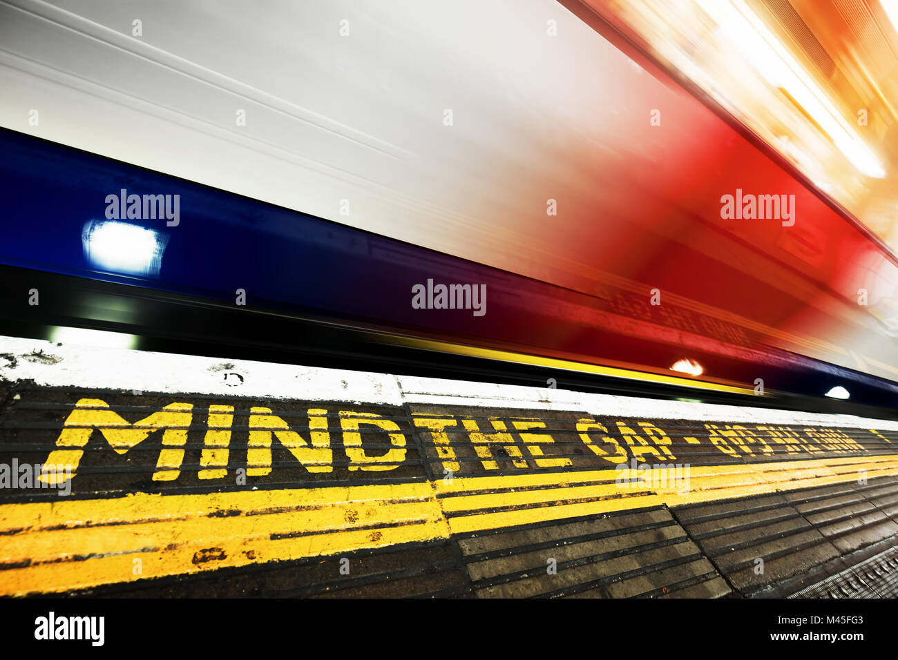 London underground. Mind the gap sign, train in motion. Stock Photo