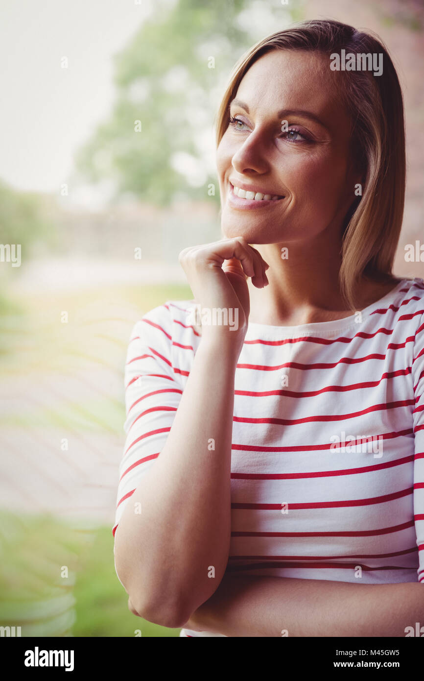 Thoughtful female student looking through the window Stock Photo - Alamy
