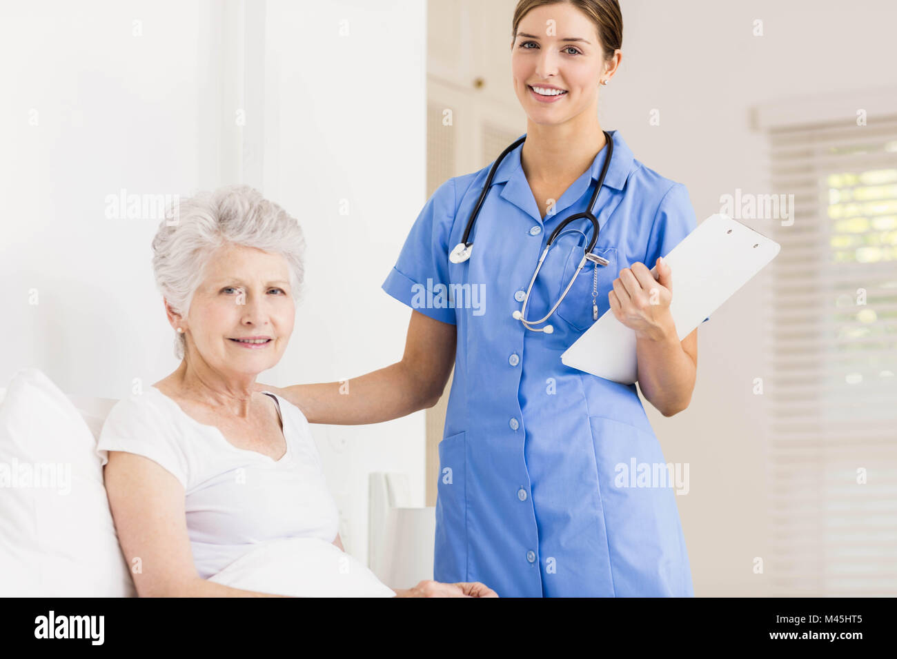 Doctor taking care of suffering senior patient Stock Photo - Alamy