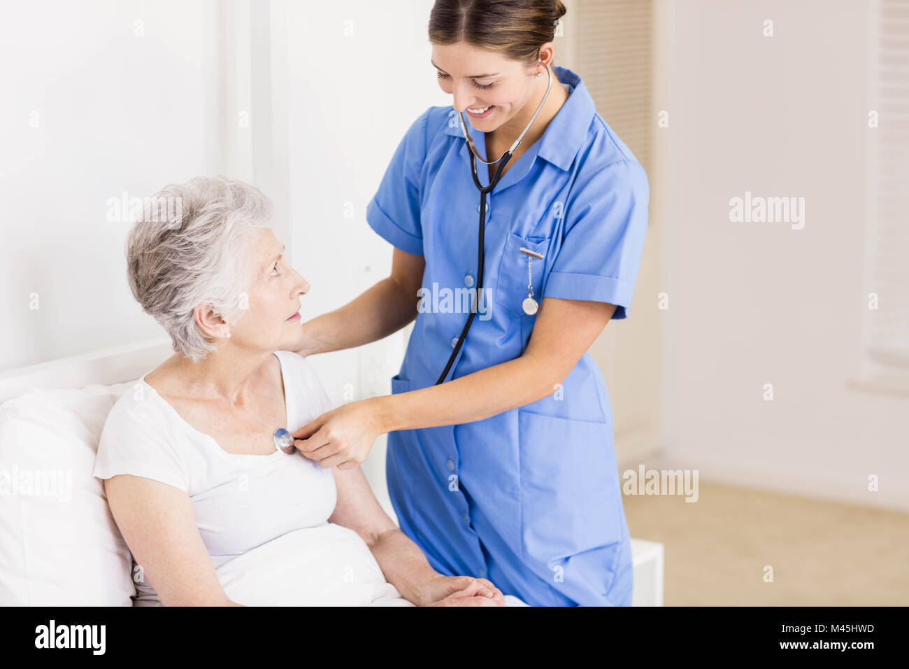 Doctor taking care of suffering senior patient Stock Photo - Alamy