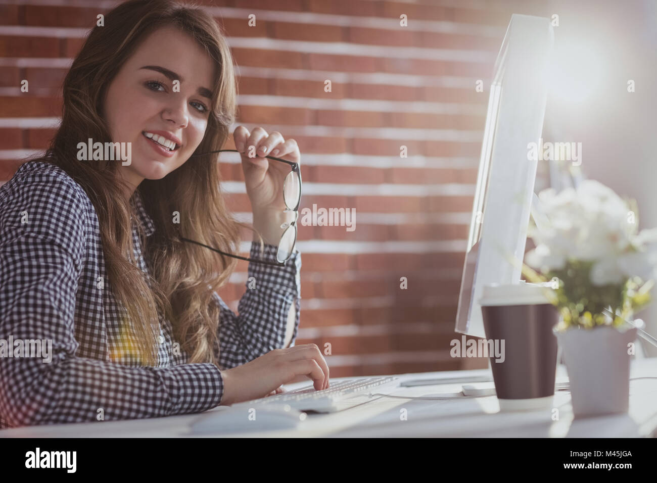 Smiling hipster businesswoman watching computer Stock Photo - Alamy