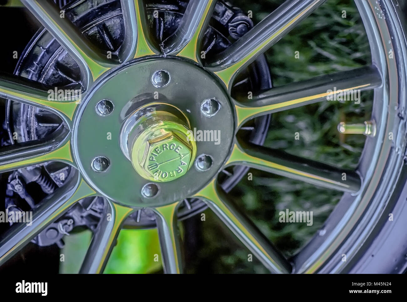Close up of a brass tire wheel from a 1911 Pierce Arrow vintage automobile. Stock Photo