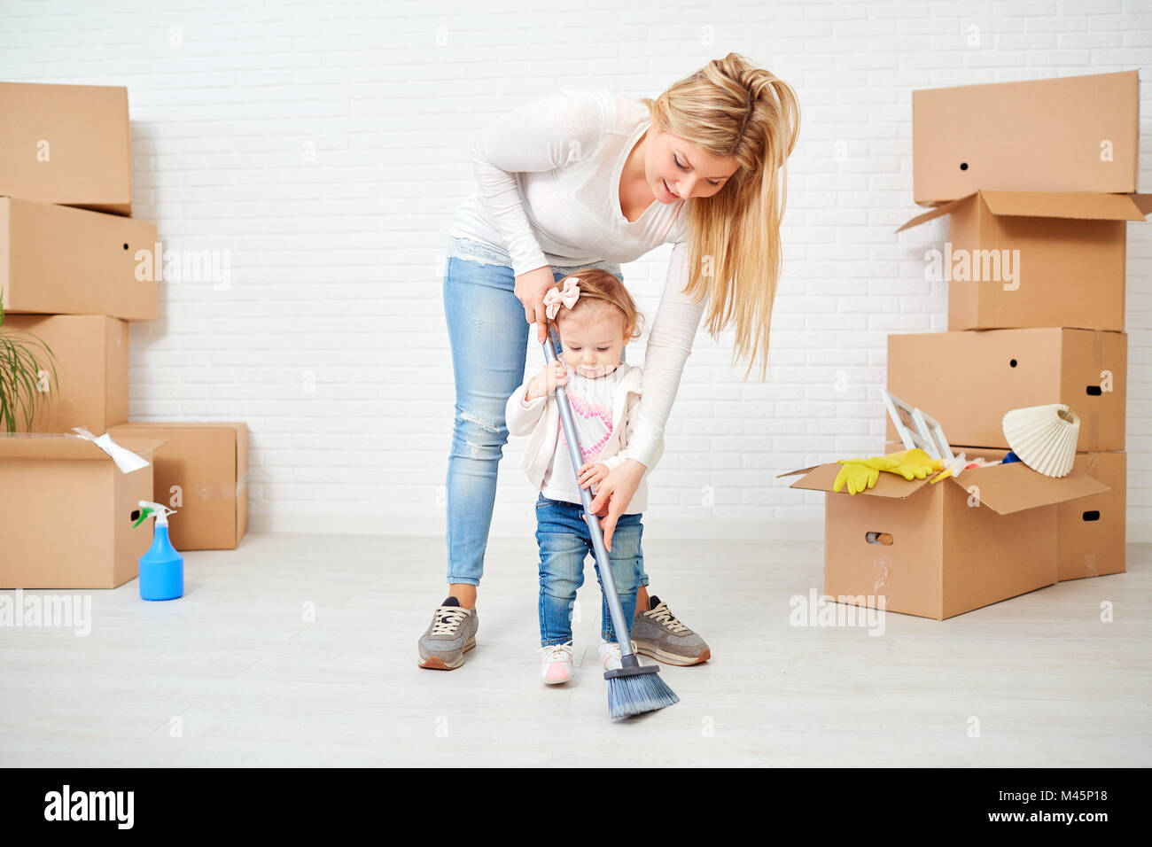 Mother and child are cleaning the house. Stock Photo
