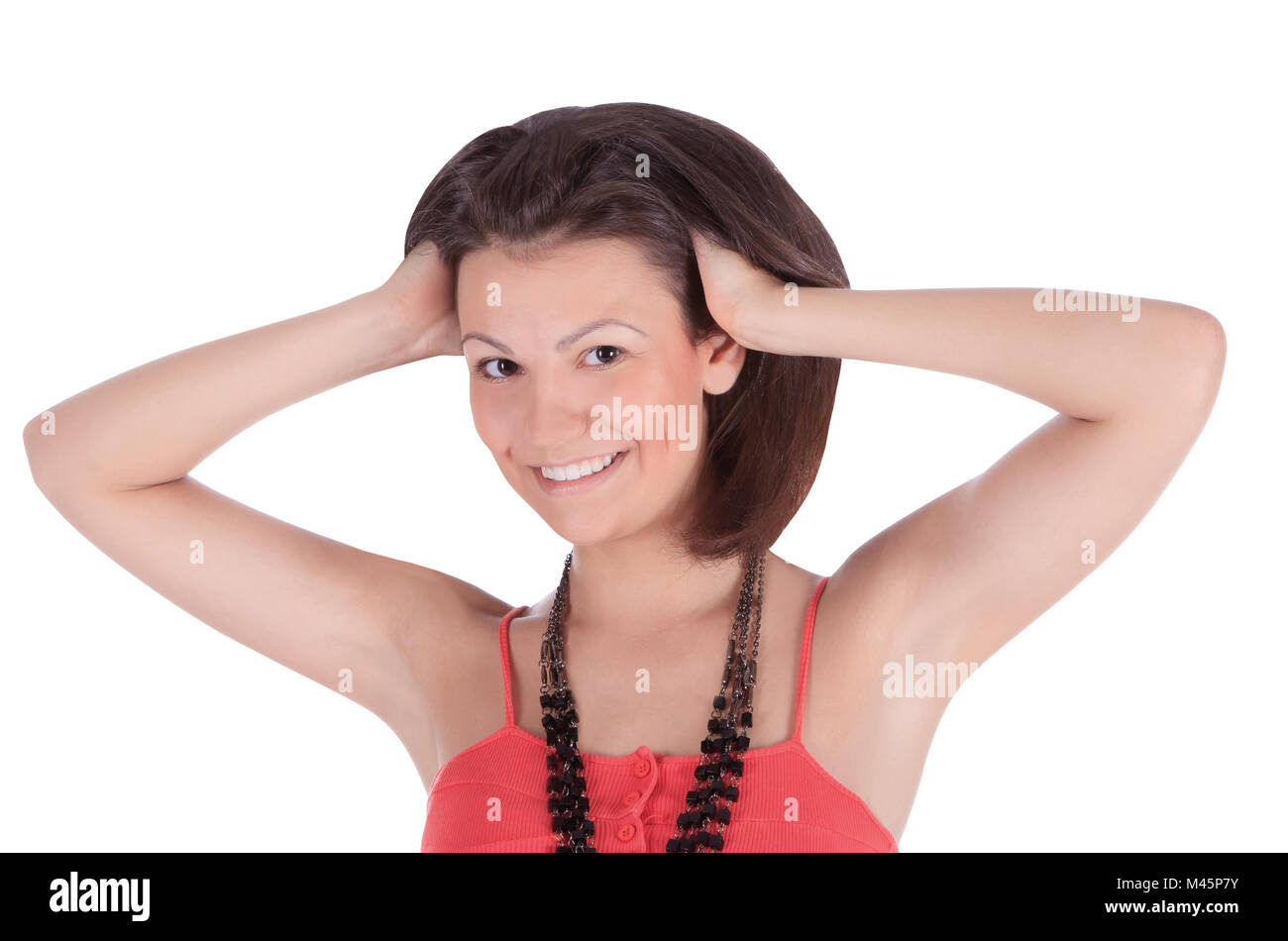 Smiling latino female in red dress posing over white Stock Photo