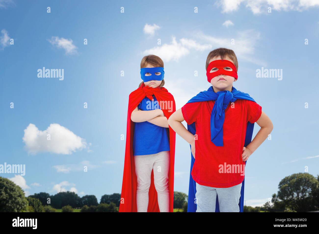 Composite image of masked kids pretending to be superheroes Stock Photo