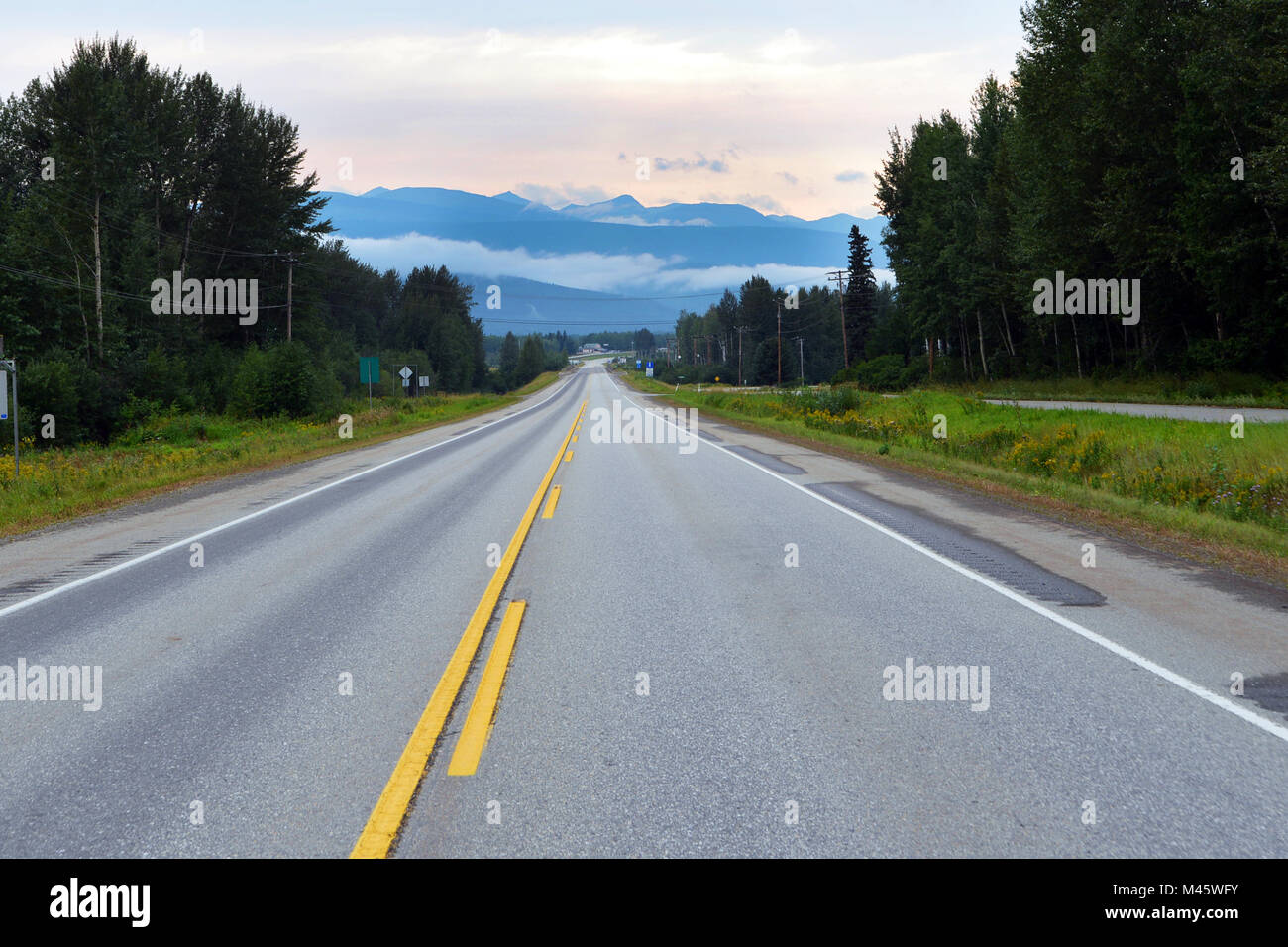 Empty road leading to Fraser Fort George, Canadian Rockies, BC Stock Photo