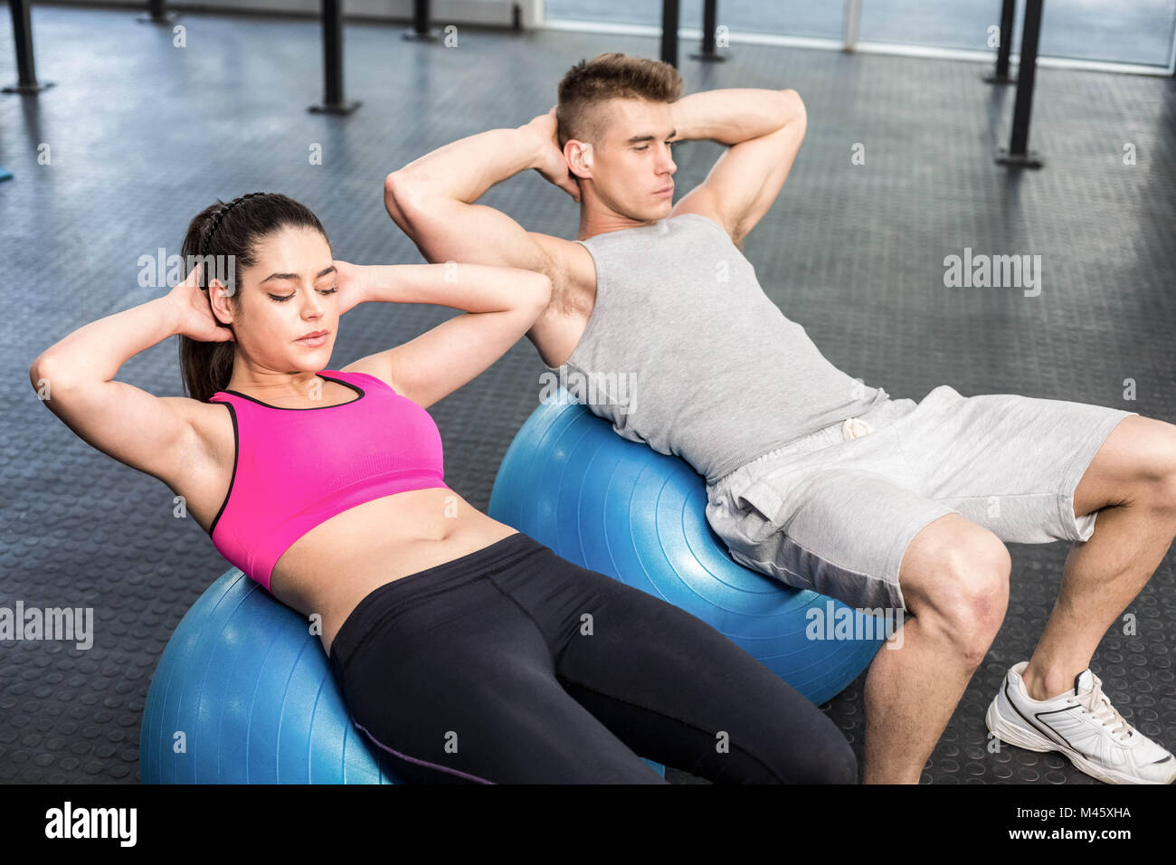 Fit couple doing abdominal crunches on fitness ball Stock Photo Alamy