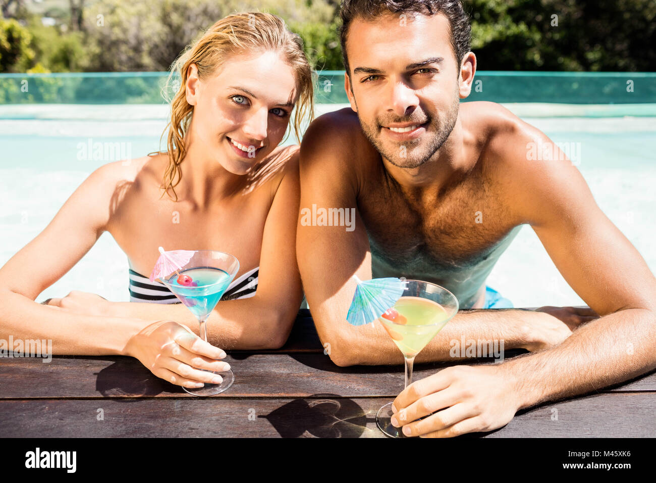 Couple in Swimwear Holding Alcohol Cocktails Near Swimming Pool Stock Photo  - Image of cocktails, muscular: 191786550