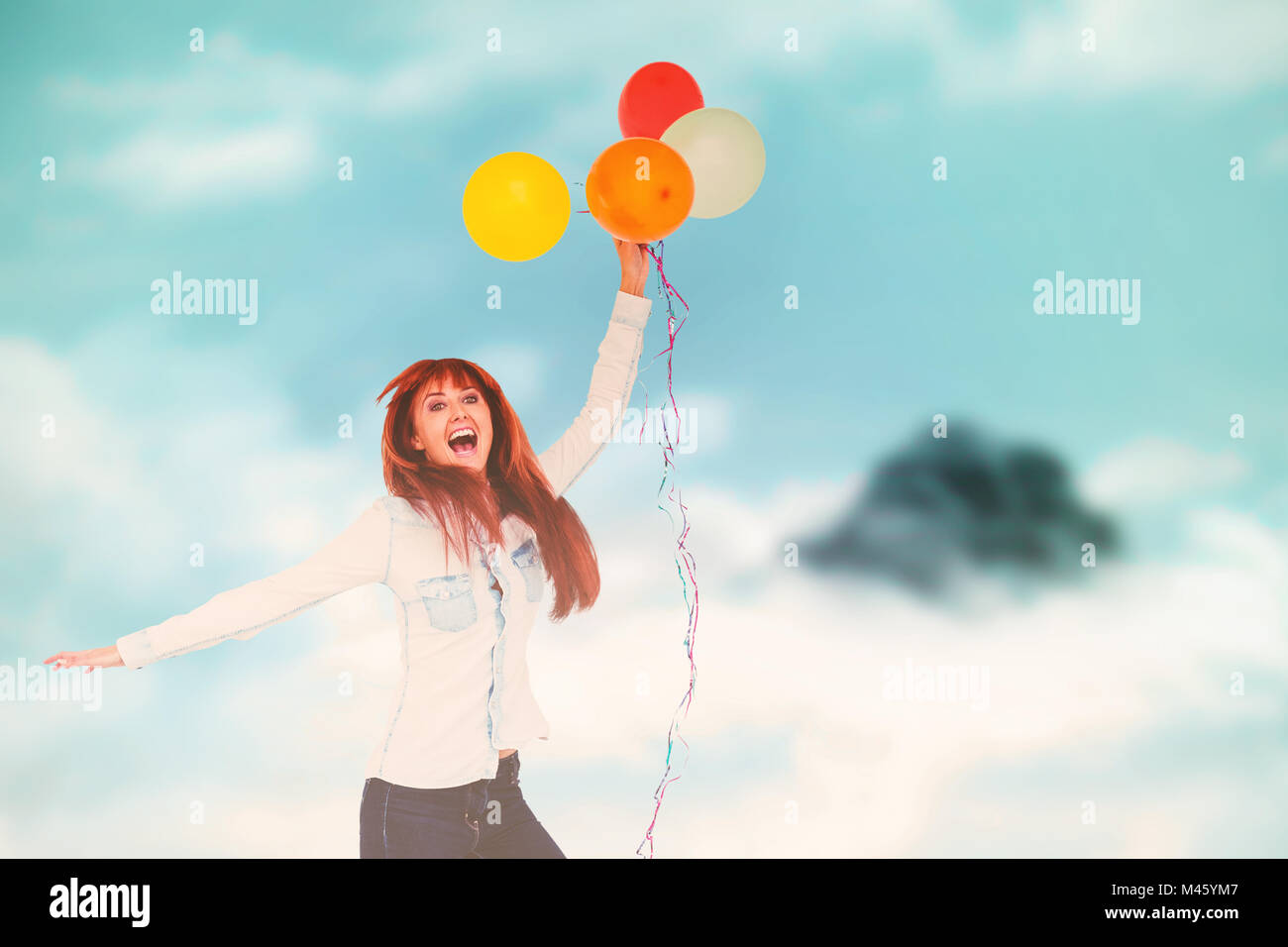 Composite image of smiling hipster woman holding balloons Stock Photo