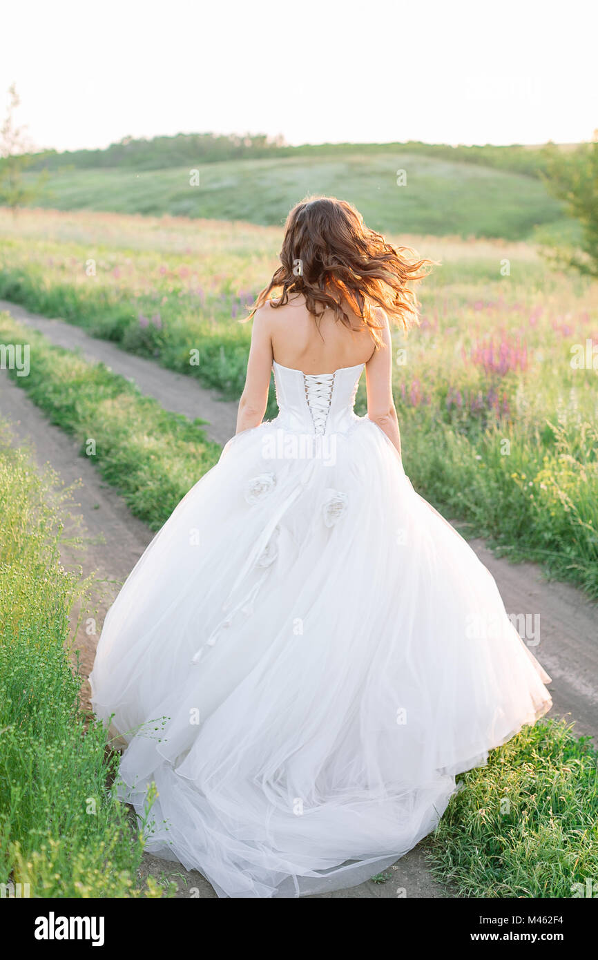 fashion, engagement, nature concept. there is a marvelous figure of young  slim bride wearing gorgeous white dress for wedding ceremony, she is  standin Stock Photo - Alamy