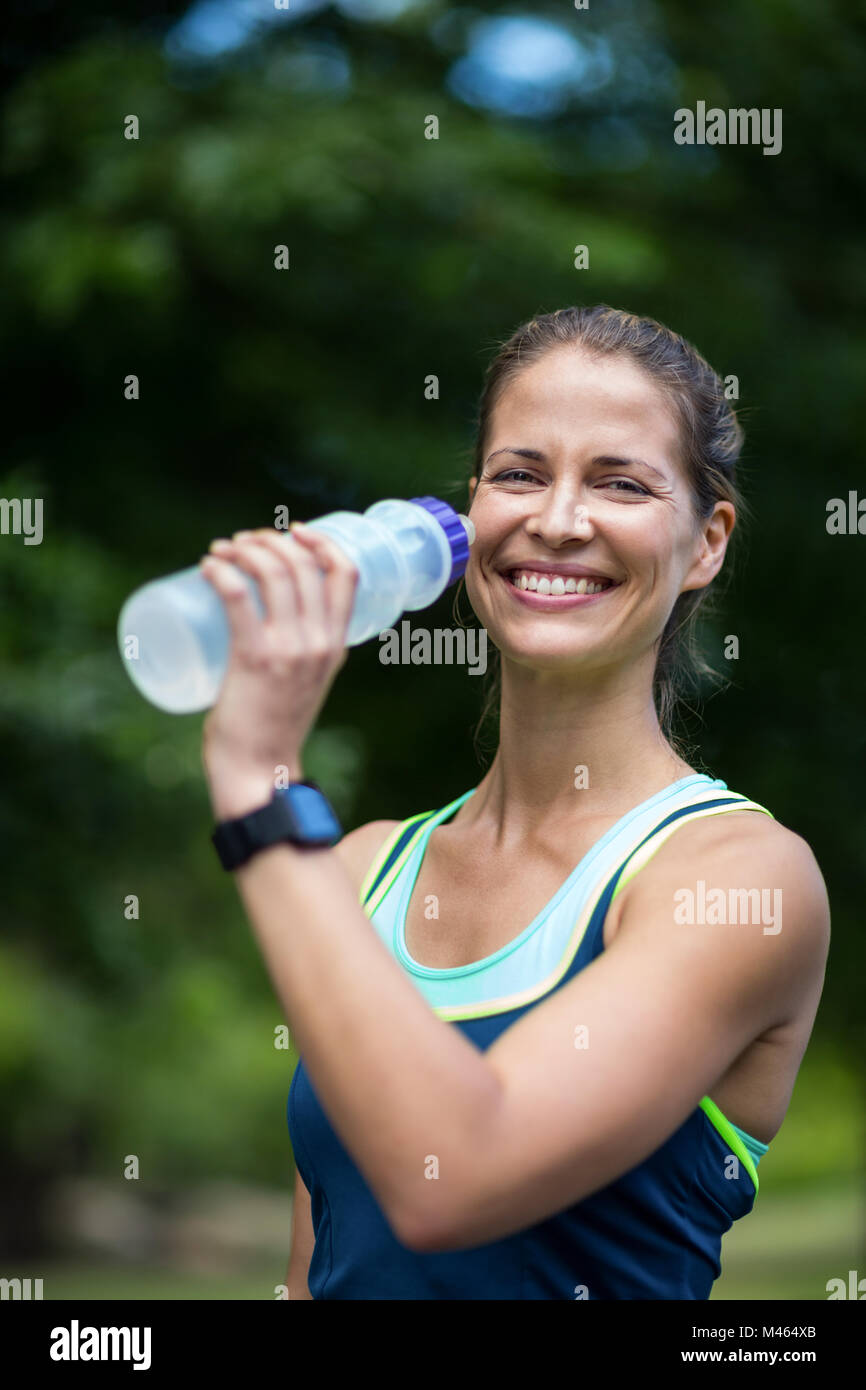 Marathon female athlete running drinking water Stock Photo Alamy